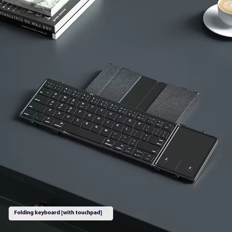Black portable folding Bluetooth keyboard for tablets and mobile phones, shown folded.