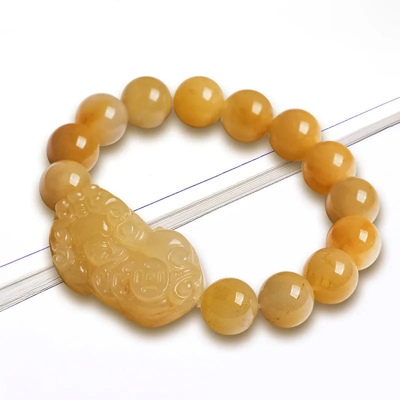Carved jinsi jade money bracelet in golden thread colour with jade bead detailing