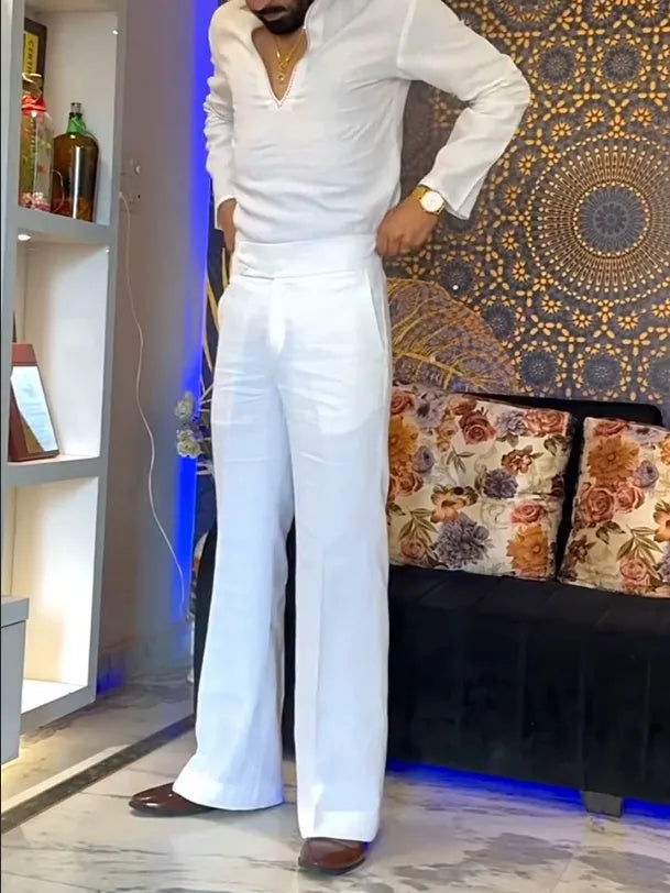 White three-piece outfit with V-neck shirt, sleeveless vest and trousers on hanger