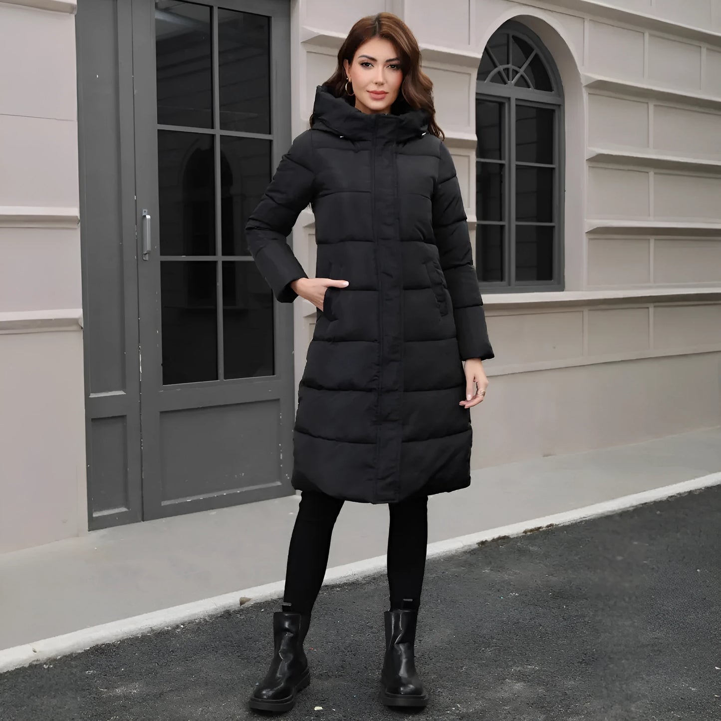Black hooded slim fit polyester jacket with long sleeves on a model showing cold-resistant construction