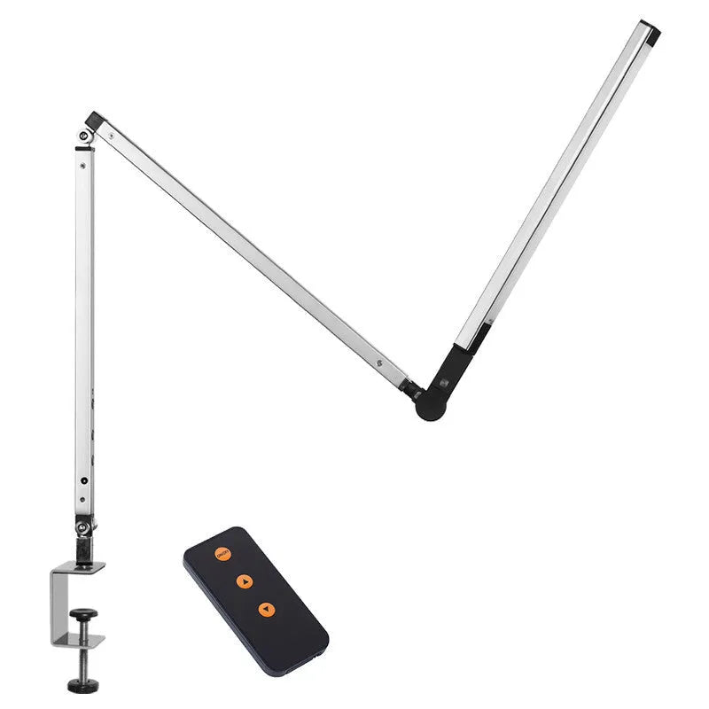 Adjustable aluminium desk lamp with remote control, shown in black with a clip attached to a desk edge.