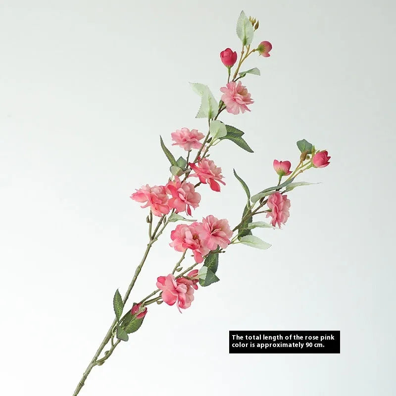 Artificial silk camellia flower in a vase, colours include white, pink, rose pink, and orange coffee.