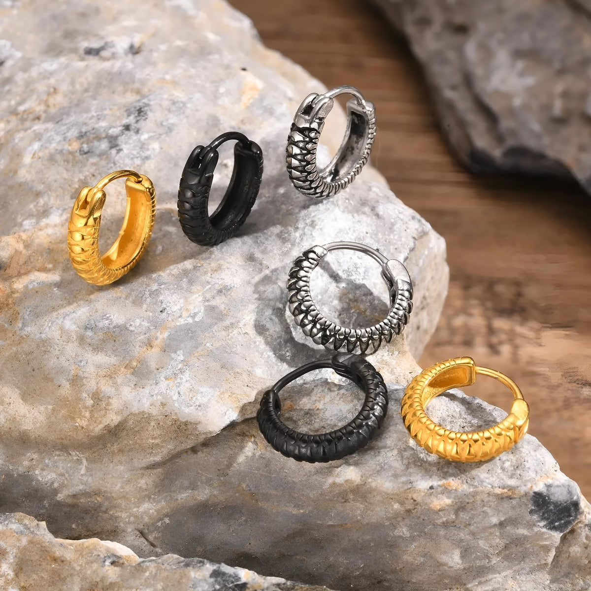 Stainless steel snake pattern earrings in black or gold finish showing textured design