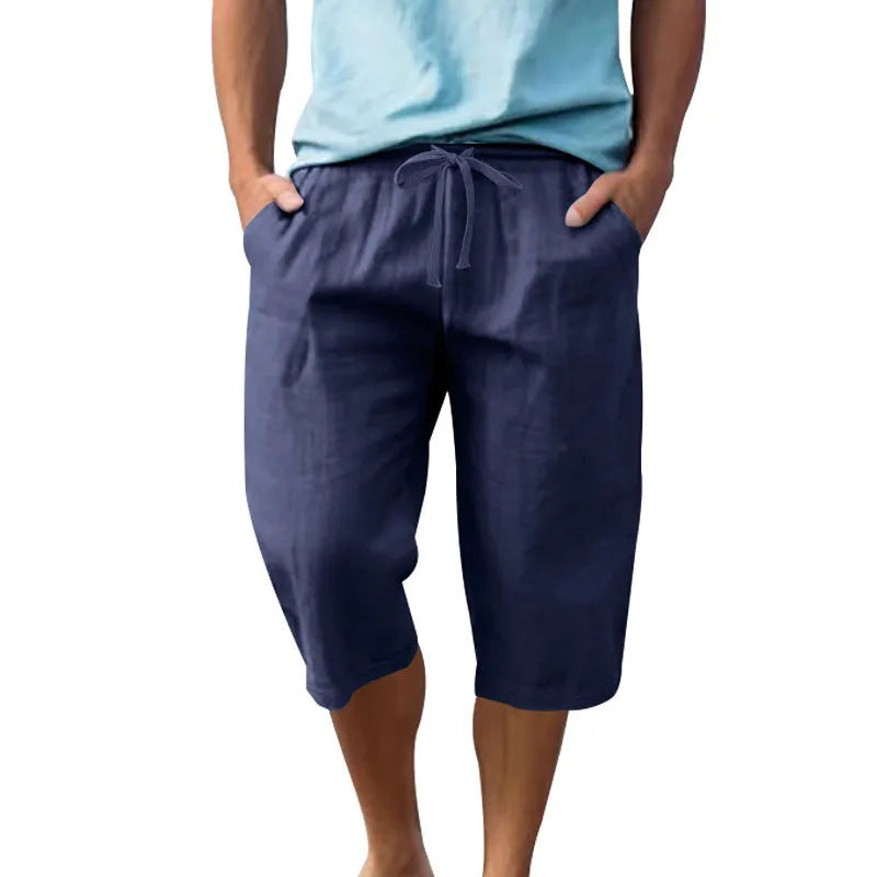 Men's loose-fit linen shorts in a solid colour with a drawstring waist and cropped leg length.