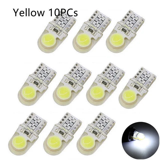 Pack of ten T10 wedge base LED car bulbs with COB chips in various colours on a white background
