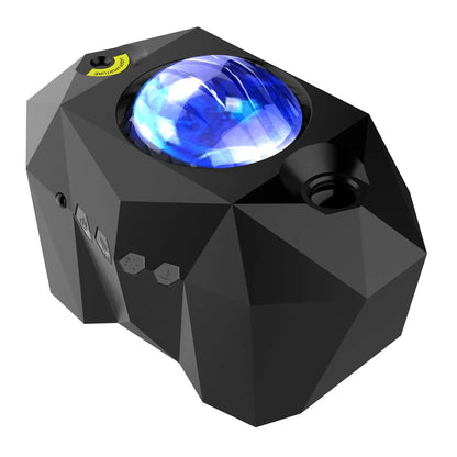 Black and white LED Dream Aurora Borealis light projector with remote control on a table