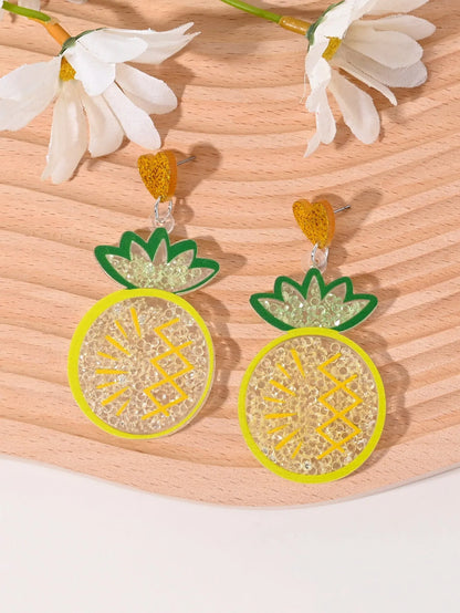 A pair of colourful acrylic earrings shaped like a strawberry and a cherry on a woman's ear.