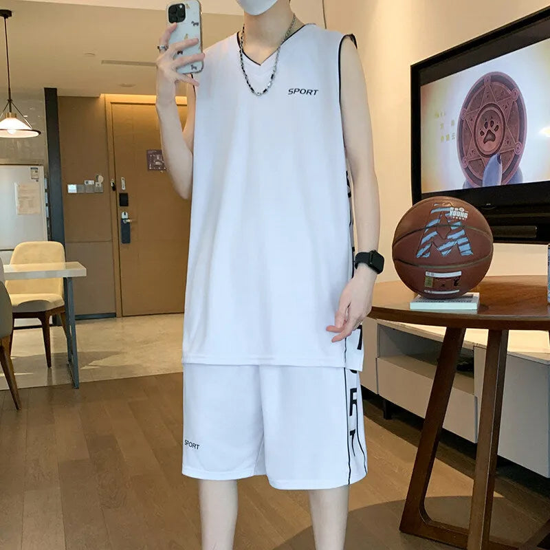 Man wearing a grey sleeveless basketball vest and matching shorts for sports.