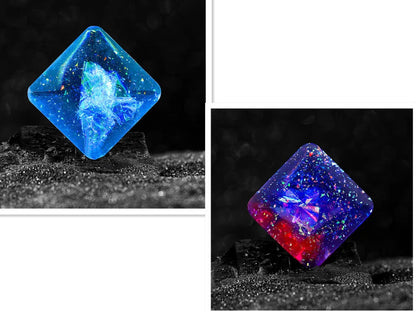 Galactic edition pocket gyro desk toy on a surface, showing its quadrilateral resin construction and celestial colour design.