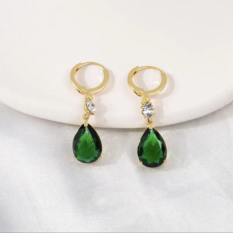 A pair of emerald green geometric teardrop drop earrings made from alloy