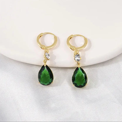 A pair of emerald green geometric teardrop drop earrings made from alloy