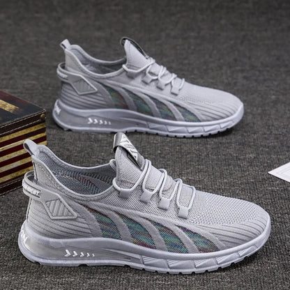Low-top casual sneakers with striped mesh upper and flat plastic sole in grey colour.