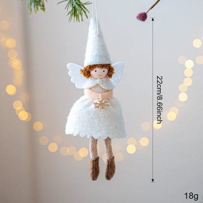 White and pink cloth felt Christmas angel skirt pendant ornament on a tree branch.