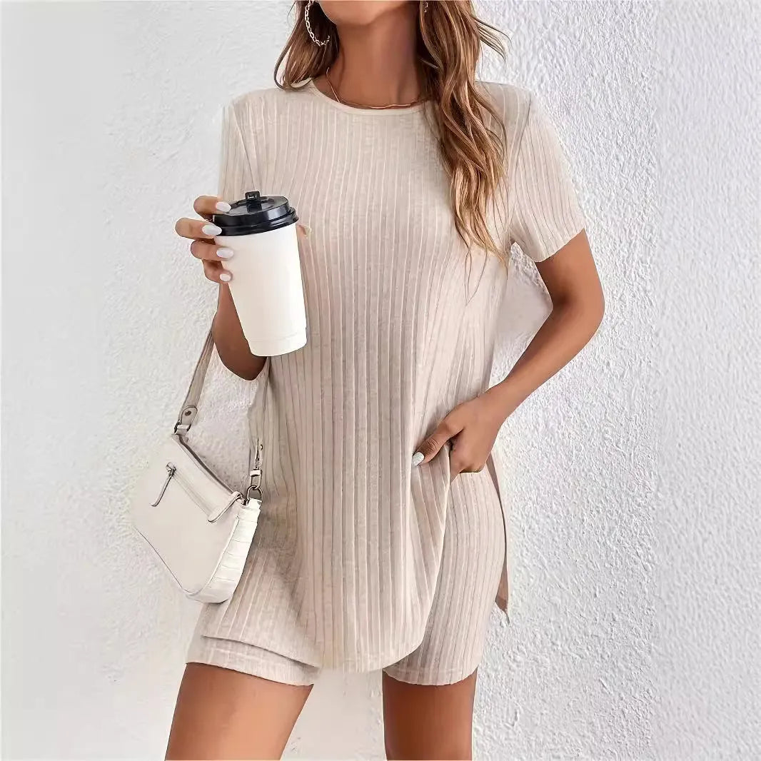 Woman wearing a grey ribbed cotton crew neck top and matching shorts from a two-piece suit set.