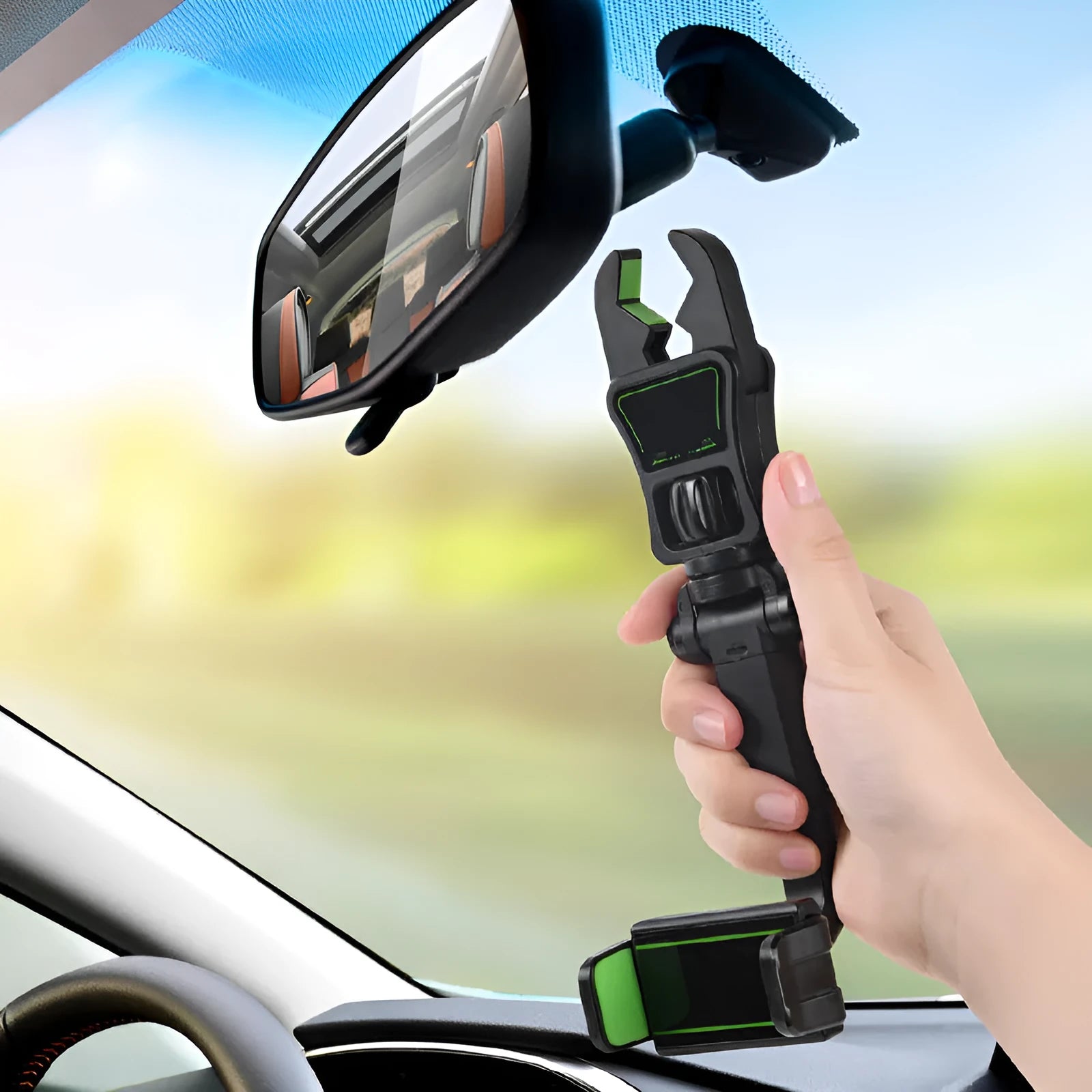 Universal car phone holder attached to a rear view mirror, shown in black and green colour.