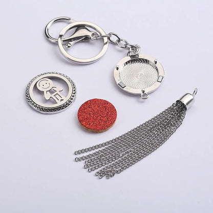 Alloy car aromatherapy pendant with tassel on 50cm chain beside coloured cotton pads for fragrance diffusion