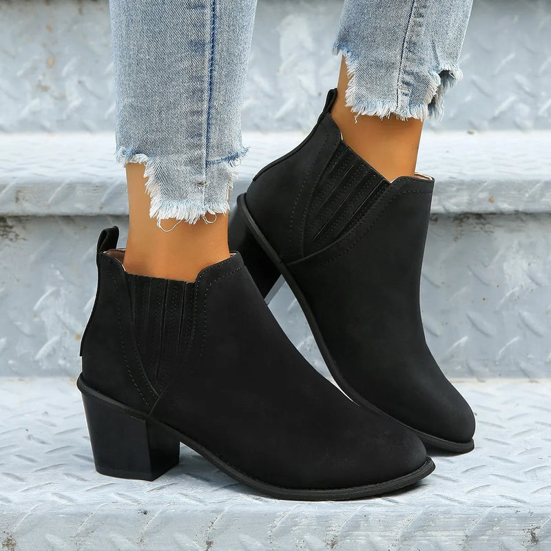 Women's ankle boots with a pointed toe, thick square heel, slip-on design, and low heel. These luxury short boots are made from artificial PU and have a faux leather inner lining and rubber sole. Available in black and brown for autumn and winter wear.