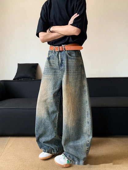 Men's distressed retro blue jeans with a slim wide-leg cut and mid waist.