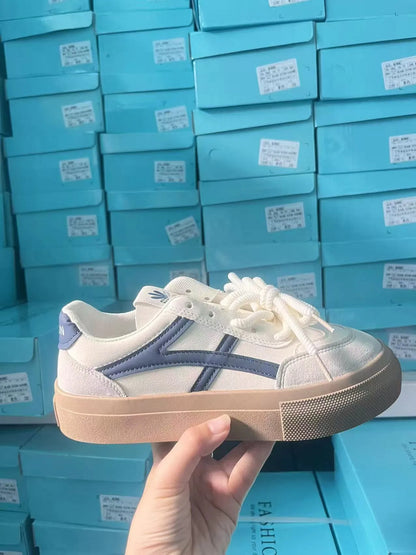 Low-top blue and brown casual lace-up shoes with round toe and flat rubber sole.