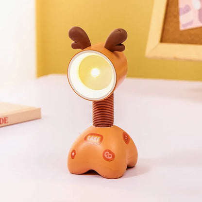 Colourful cartoon character magnetic DIY night light on a desk with adjustable head.
