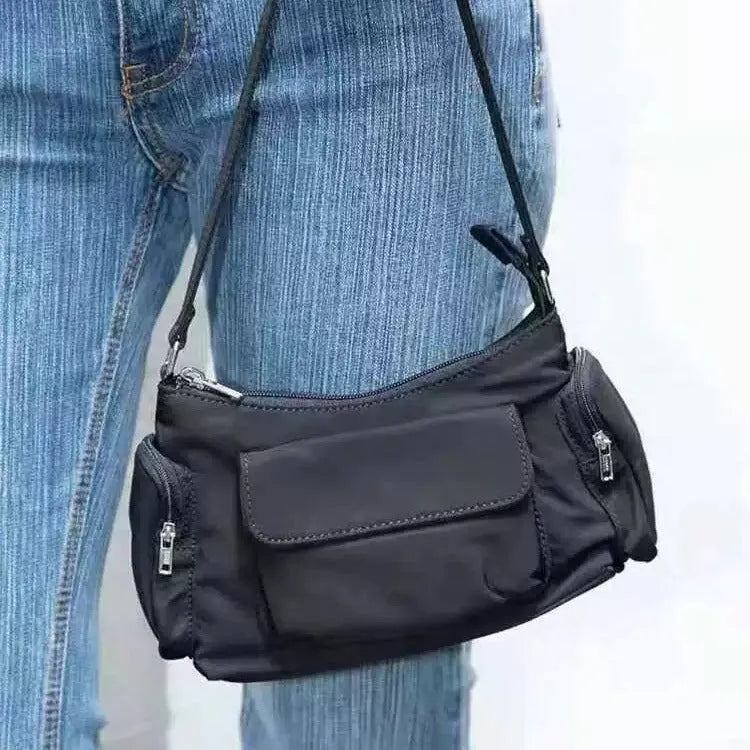 Black lightweight nylon shoulder bag with two pockets and side stitch detailing, dimensions 24cm x 9cm x 14cm.