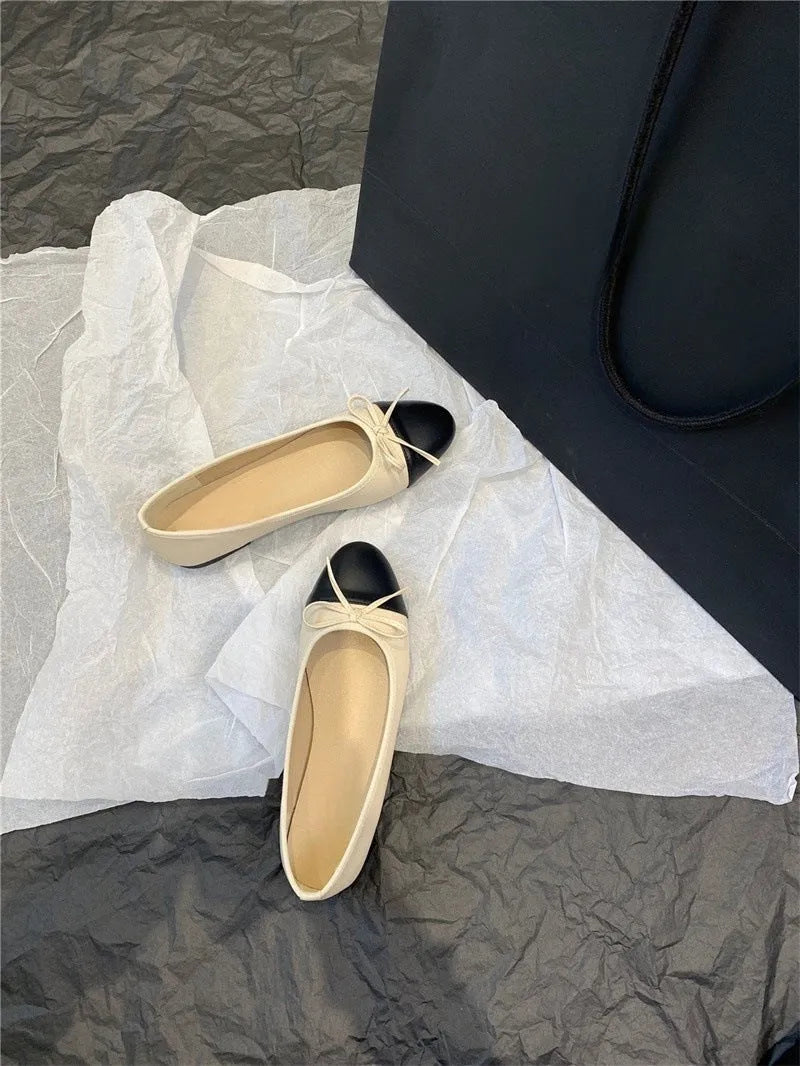 Apricot flat ballet shoes with a bowknot, round toe, and soft rubber sole.