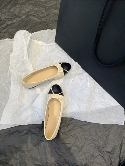 Apricot flat ballet shoes with a bowknot, round toe, and soft rubber sole.