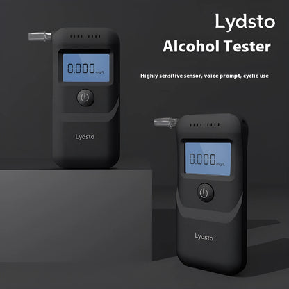 Black portable digital alcohol breath tester with display on a white background.