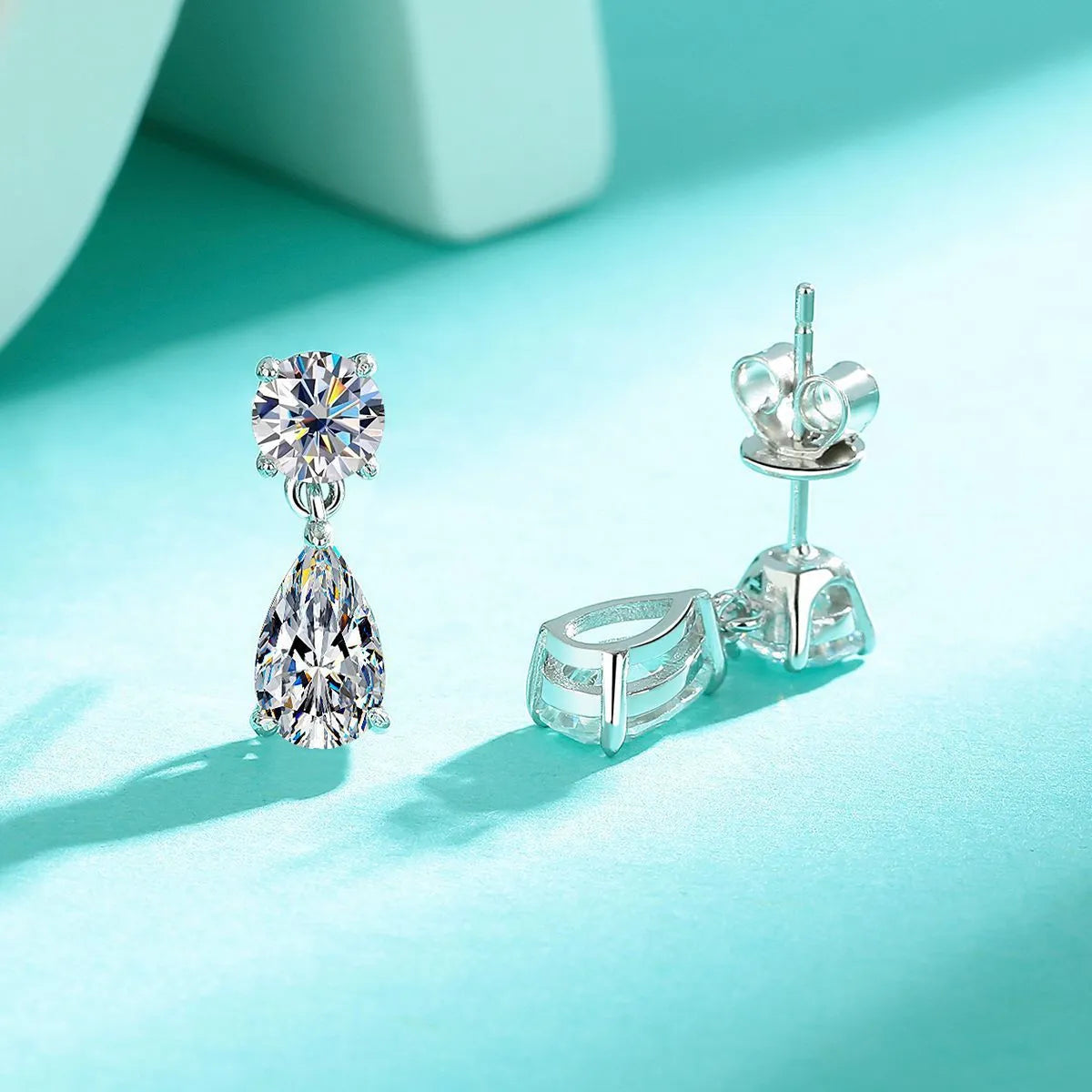 925 sterling silver water drop moissanite stud earrings with two round stones in gold or silver finish.