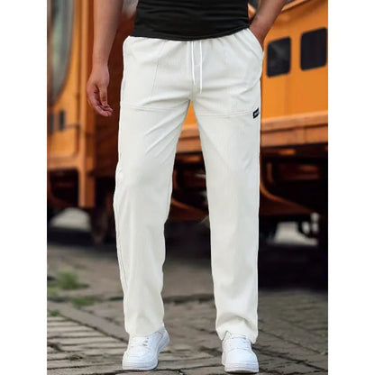 Men's light grey polyester trousers with an elasticated waistband laid flat