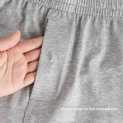 Men's light grey cotton boxer shorts with a loose fit and high waist on a plain background.