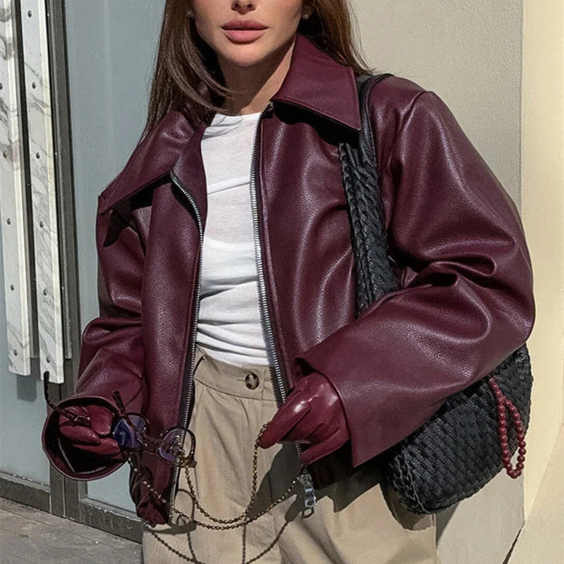 A stylish faux leather jacket with a zipper closure and lapel, available in burgundy and black colors.