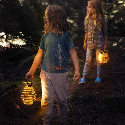Solar-powered pineapple-shaped outdoor lights with a weather-resistant metal frame and warm white LED bulbs