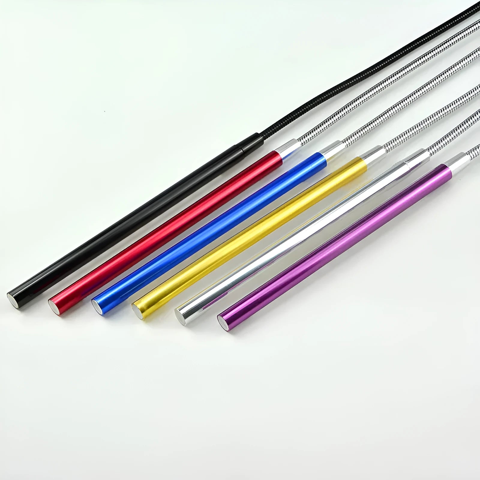Spiral shaped silver aluminium USB LED desk lamp bent on a wooden desk.