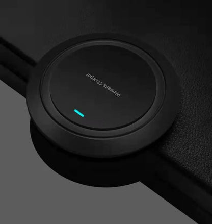 Round desktop wireless charger showing black and white colour options with USB cable