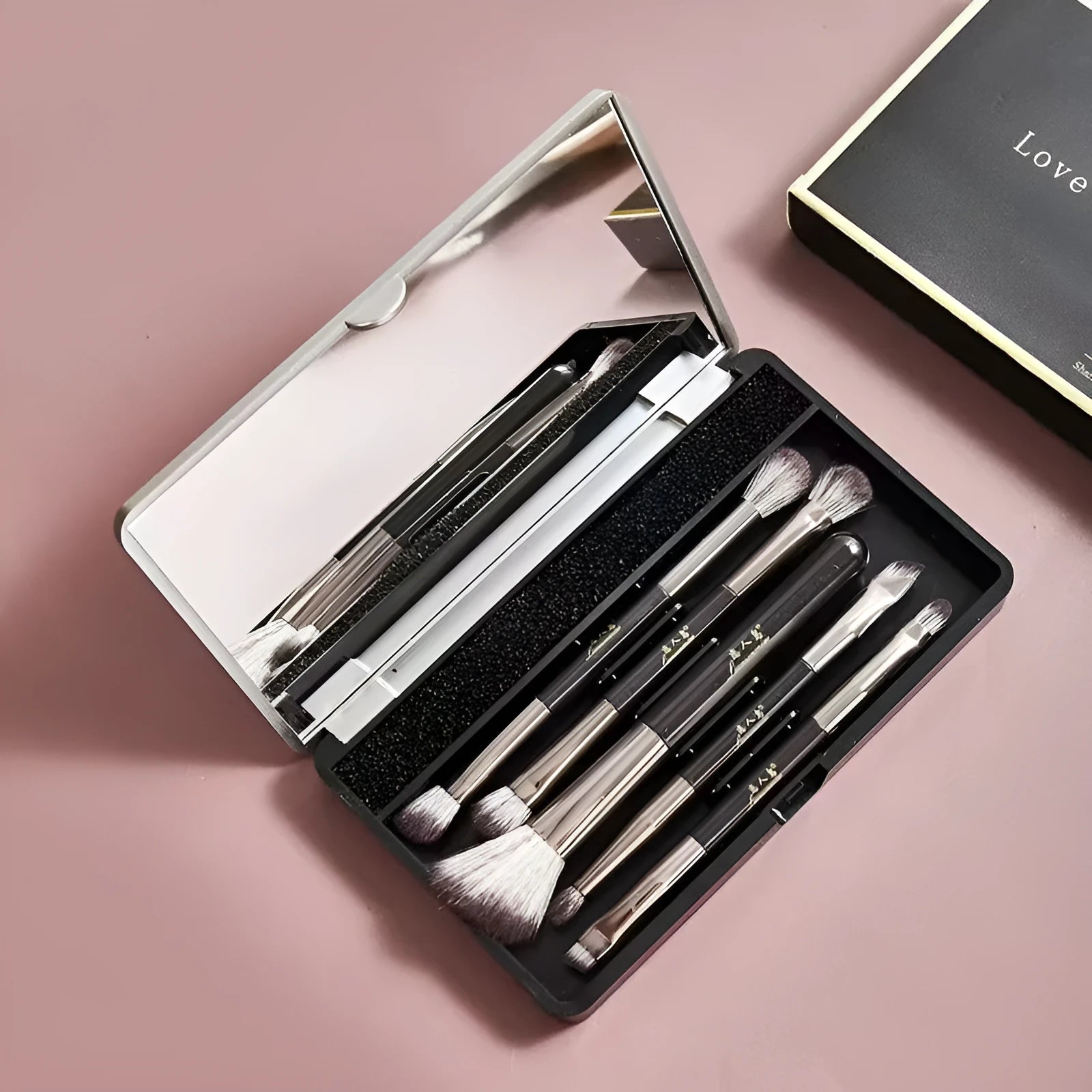 Portable makeup brush set with mirror showing artificial fibre brushes with silver handles