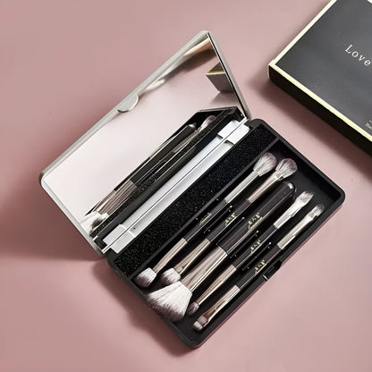 Portable makeup brush set with mirror showing artificial fibre brushes with silver handles