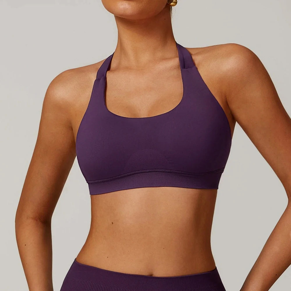 Women's halter yoga bra with hollow design in plum purple colour showing medium support construction