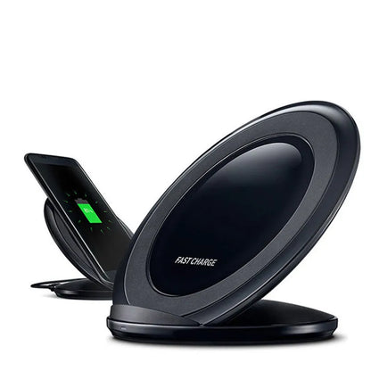 Black Qi wireless charging pad for Samsung Galaxy Note Edge on a desk.