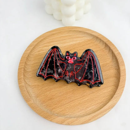 Halloween hair clip with bat design incorporating shark and vinegar elements