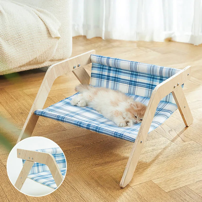 Elevated wooden cat beach chair bed with cloth lounging surface in blue or green.