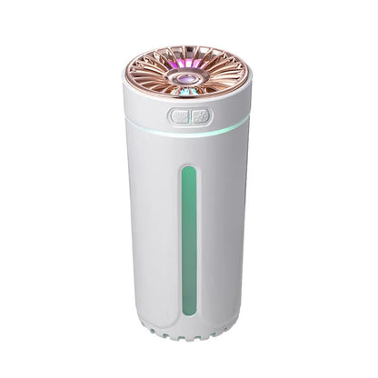 Black portable humidifier with LED lights beside car cup holder showing mist output