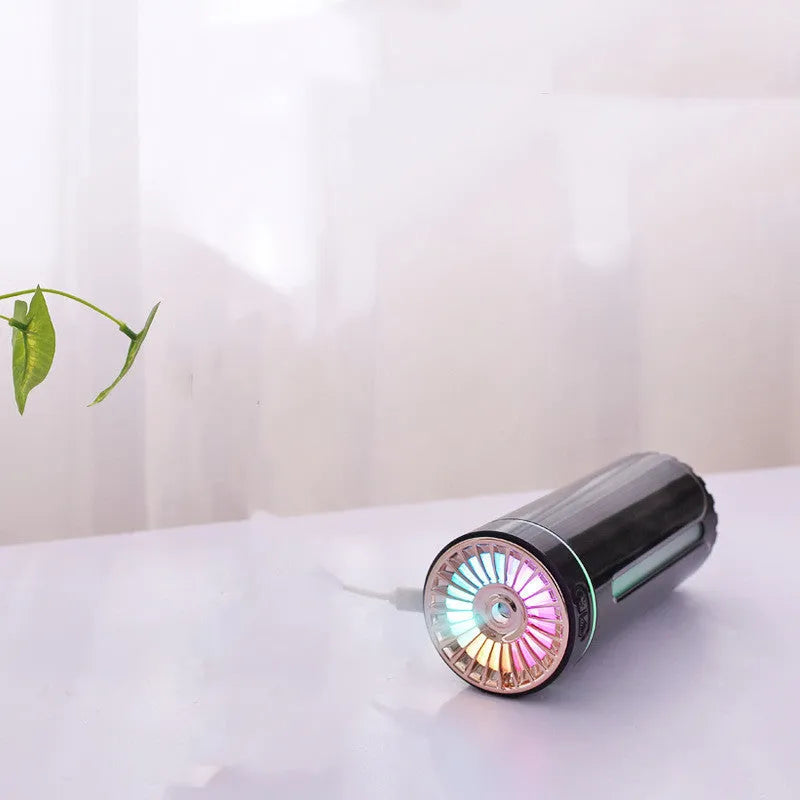 Black portable humidifier with LED lights beside car cup holder showing mist output