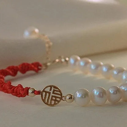 Women's pearl bracelet with braided red rope and geometric fu character charm