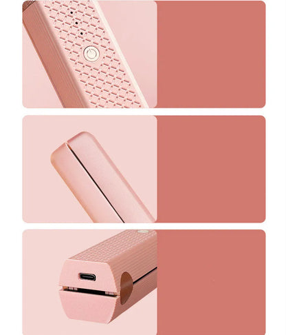 Pink and green cordless mini USB hair straightener and curler with ceramic plates.