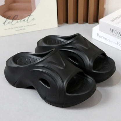 Women's white thick-soled EVA slippers with a round toe on a beach background.