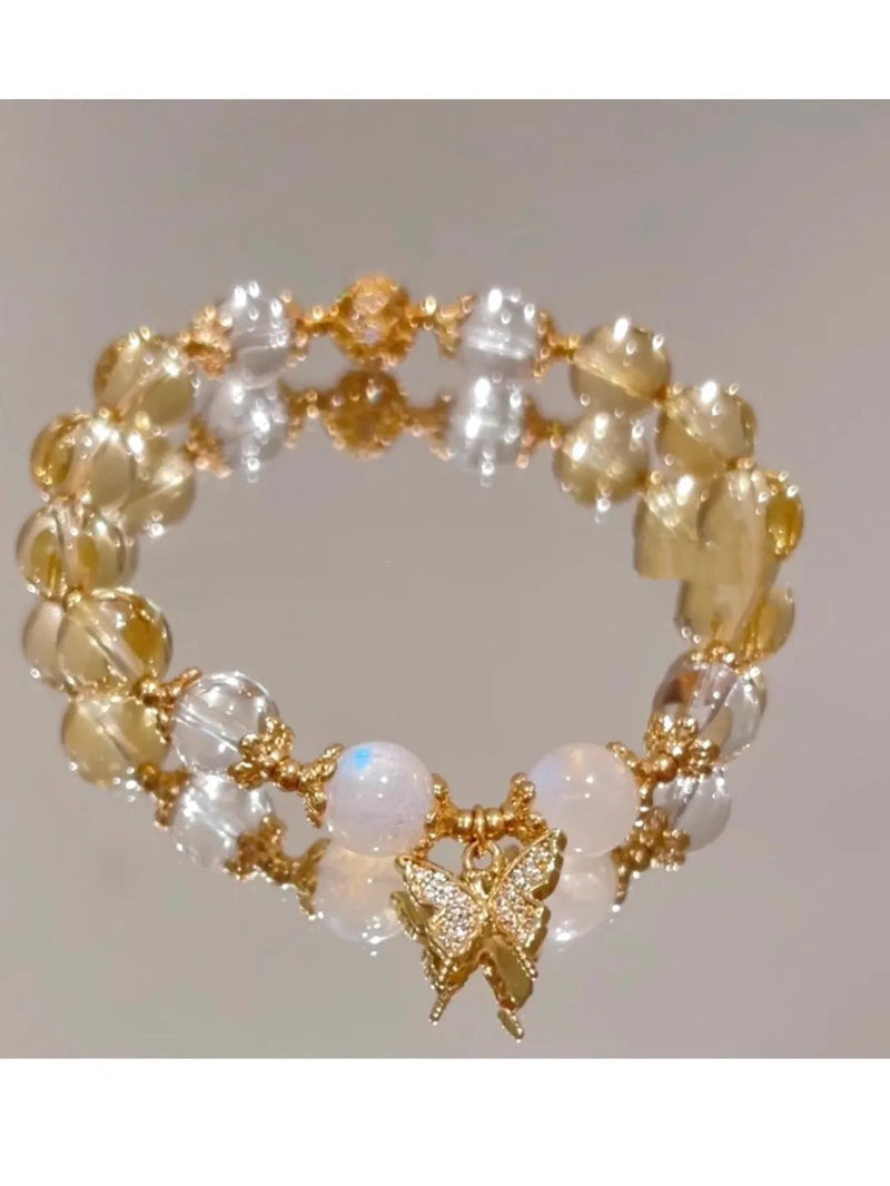 Chinese style women's crystal beaded bracelet in a diamond shape design featuring a citrine colour butterfly charm, suitable for everyday wear and adding a delicate accent to outfits.