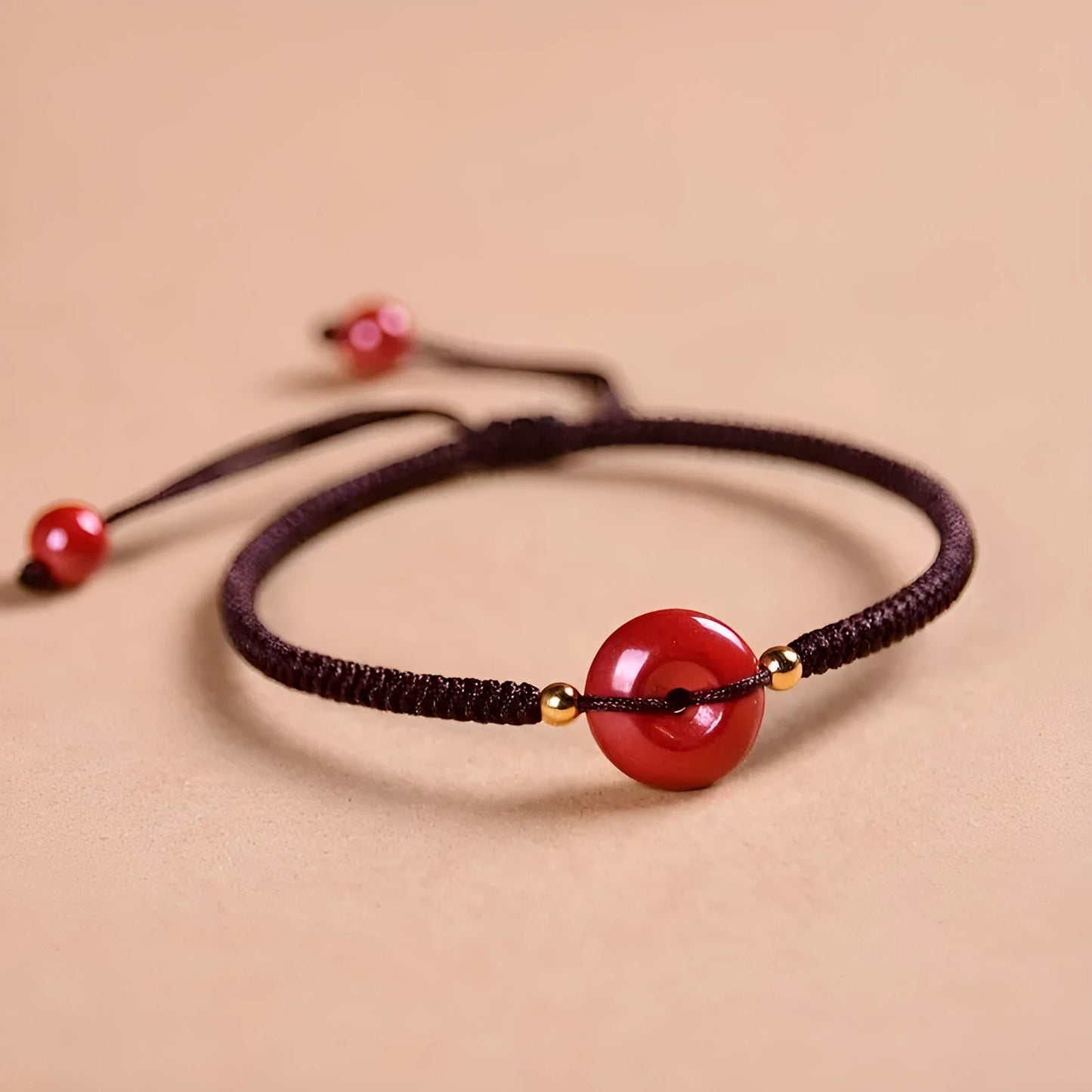 Cinnabar heart-shaped bracelet with safety buckle closure and adjustable coloured rope in traditional Chinese design