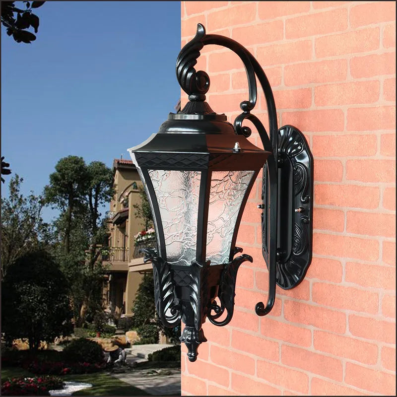 Black European-style solar outdoor wall lamp with remote control on a brick wall.