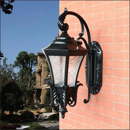 Black European-style solar outdoor wall lamp with remote control on a brick wall.